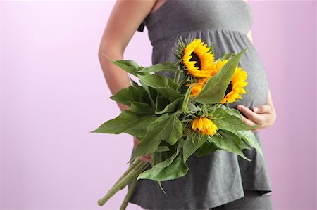 simsearch:400-04875116,k - Pregnant woman holding yellow flowers. Stock Photo - Budget Royalty-Free & Subscription, Code: 400-04631372