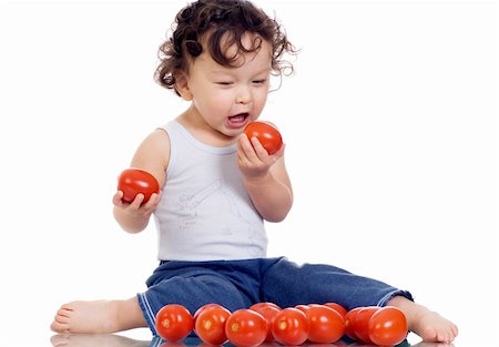 Child with tomato,isolated on a white background. Stock Photo - Budget Royalty-Free & Subscription, Code: 400-04632997