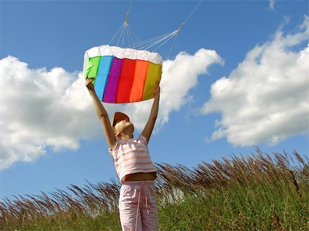 child starts flying kite against blue sky with clouds Stock Photo - Budget Royalty-Free & Subscription, Code: 400-04633343