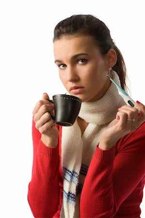 simsearch:400-05716904,k - nice brunette with a thermometer fighting against a cold with a cup of hot drink Stock Photo - Budget Royalty-Free & Subscription, Code: 400-04644594