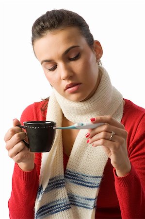 simsearch:400-05716904,k - woman with a cup of hot drink looking sick checking her body temperature Stock Photo - Budget Royalty-Free & Subscription, Code: 400-04644595