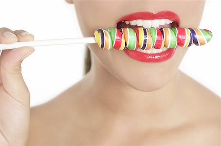simsearch:400-04932642,k - Colorful Lollypop in perfect woman teeth and red lips mouth Photographie de stock - Aubaine LD & Abonnement, Code: 400-04649229