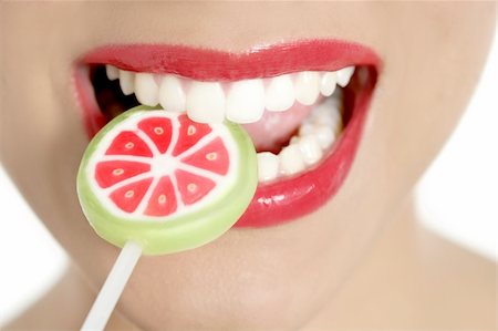 simsearch:400-04932642,k - Colorful Lollypop in perfect woman teeth and red lips mouth Photographie de stock - Aubaine LD & Abonnement, Code: 400-04649230