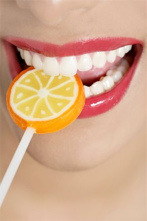 simsearch:400-04932642,k - Colorful Lollypop in perfect woman teeth and red lips mouth Photographie de stock - Aubaine LD & Abonnement, Code: 400-04649231