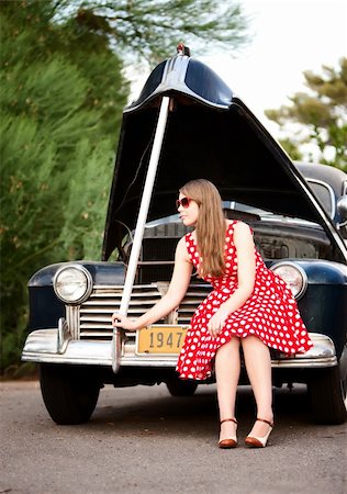 Pretty girl with hood open on vintage car Stock Photo - Budget Royalty-Free & Subscription, Code: 400-04642924