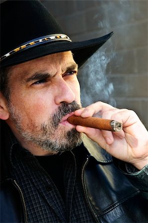 Man with beard in cowboy hat smoking cigar Stock Photo - Budget Royalty-Free & Subscription, Code: 400-04654032