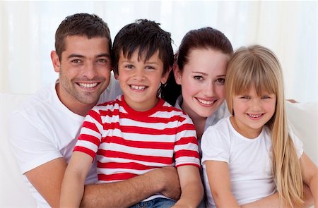 simsearch:400-04193348,k - Portrait of family in living-room sitting on sofa together Stock Photo - Budget Royalty-Free & Subscription, Code: 400-04654583
