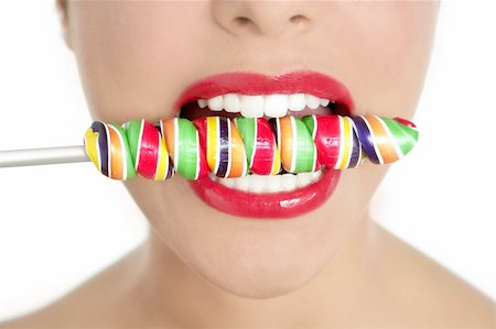 simsearch:400-04932642,k - Colorful Lollypop in perfect woman teeth and red lips mouth Photographie de stock - Aubaine LD & Abonnement, Code: 400-04654711