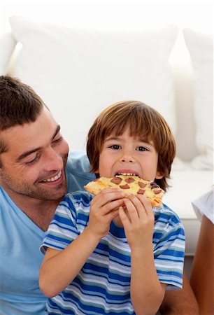 simsearch:400-04193348,k - Little boy eating pizza in living-room with his father Stock Photo - Budget Royalty-Free & Subscription, Code: 400-04654736