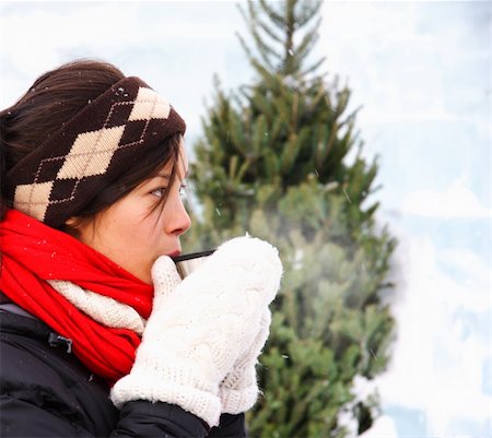 Woman drinking hot coffee or tea outdoors in winter. The background is an ice wall. Stock Photo - Budget Royalty-Free & Subscription, Code: 400-04657943