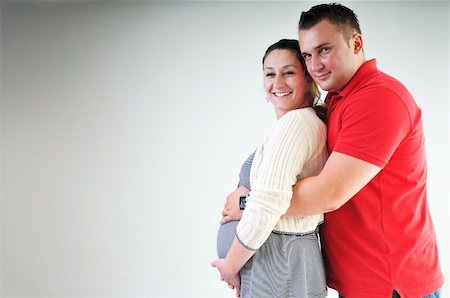 young family couple together in studio isolated on white. happy and waiting for baby Stock Photo - Budget Royalty-Free & Subscription, Code: 400-04659397