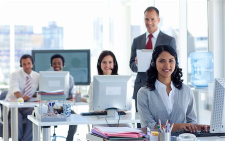 Attractive male supervisor writing notes in a call center Stock Photo - Budget Royalty-Free & Subscription, Code: 400-04652985