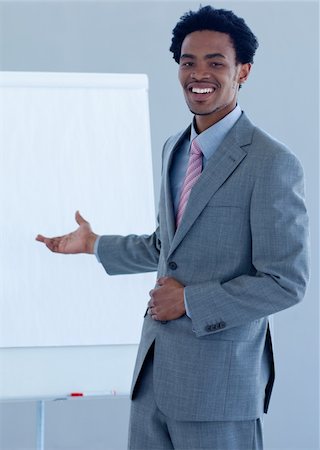 simsearch:400-05710382,k - Afro-American businessman giving a presentation on the whiteboard Photographie de stock - Aubaine LD & Abonnement, Code: 400-04653145