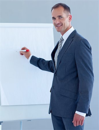 simsearch:400-05710386,k - Mature businessman writing in a whiteboard in a presentation Stock Photo - Budget Royalty-Free & Subscription, Code: 400-04653149