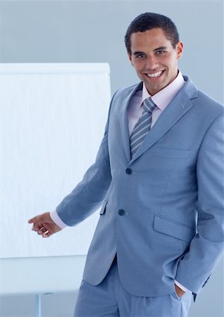 simsearch:400-05710386,k - Young businessman pointing at a whiteboard in a presentation Stock Photo - Budget Royalty-Free & Subscription, Code: 400-04653154