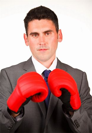 Serious businessman with boxing gloves looking at the camera Foto de stock - Super Valor sin royalties y Suscripción, Código: 400-04653177