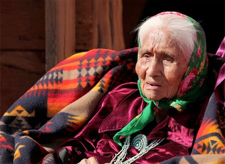 An elderly Native American woman sits among blankets. She is head and shoulders viewable and looking away from the camera. Horizontally framed shot. Stock Photo - Budget Royalty-Free & Subscription, Code: 400-04653438