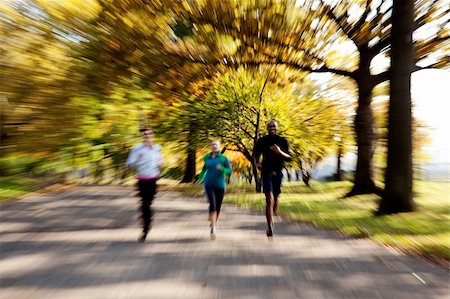 Three people jogging in the park with zoom blur Stock Photo - Budget Royalty-Free & Subscription, Code: 400-04653601