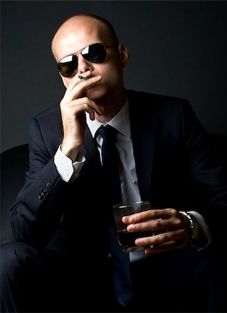 simsearch:400-04131198,k - young businessman smoking a cigarette and having a superior attitude Stock Photo - Budget Royalty-Free & Subscription, Code: 400-04664816