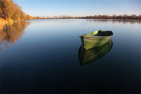 simsearch:400-05308802,k - Single Row boat on Lake with Reflection in the Water Stock Photo - Budget Royalty-Free & Subscription, Code: 400-04660089