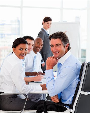 simsearch:400-04113367,k - Multi-ethnic business team at a meeting smiling at the camera Stock Photo - Budget Royalty-Free & Subscription, Code: 400-04660440