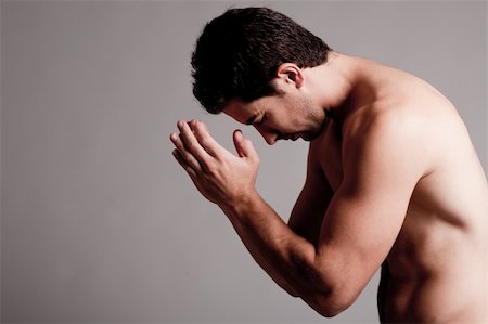 simsearch:400-05361704,k - Shirtless man praying in the grey isolated background Stock Photo - Budget Royalty-Free & Subscription, Code: 400-04661155