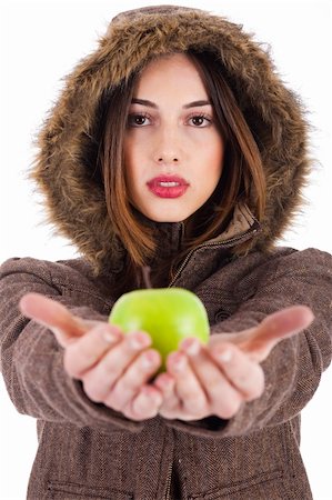 simsearch:400-04607386,k - Beautiful young lady showing green apple wearing a fur coat with head cap on a white background Stock Photo - Budget Royalty-Free & Subscription, Code: 400-04661203