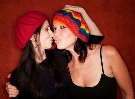 simsearch:400-06204561,k - Two attractive women friends in knit caps kissing Stock Photo - Budget Royalty-Free & Subscription, Code: 400-04663003