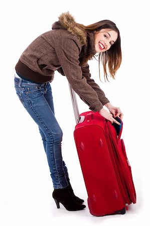 simsearch:400-04158321,k - Young women ready for winter travel cheking her suitcase indoor studio Stock Photo - Budget Royalty-Free & Subscription, Code: 400-04674606