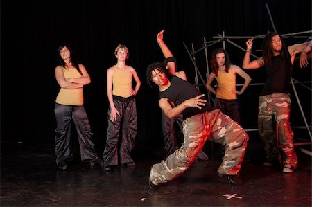 sexual woman on top of man - A group of female and one male freestyle hip-hop dancers during dance training session on stage. Lit with spotlights Stock Photo - Budget Royalty-Free & Subscription, Code: 400-04676517