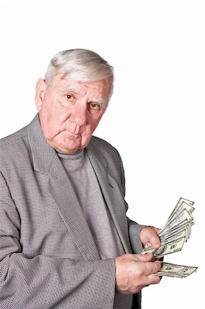 retired rich old man - Elderly man considers money. Isolated on a white background Stock Photo - Budget Royalty-Free & Subscription, Code: 400-04671200
