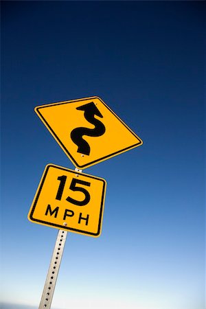 Curvy road warning sign with second sign saying 15 mph. Vertical shot. Stock Photo - Budget Royalty-Free & Subscription, Code: 400-04671891