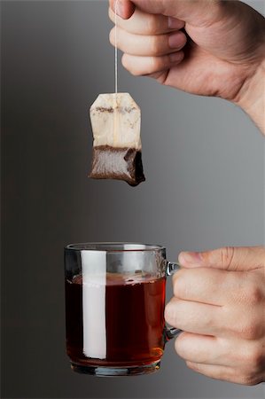 Hand lifting a wet used tea bag from a glass tea mug Stock Photo - Budget Royalty-Free & Subscription, Code: 400-04673297