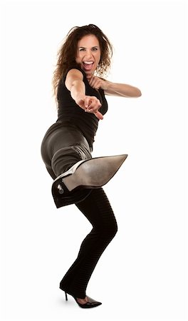 Tough woman in high heels kicking at camera Stock Photo - Budget Royalty-Free & Subscription, Code: 400-04684145