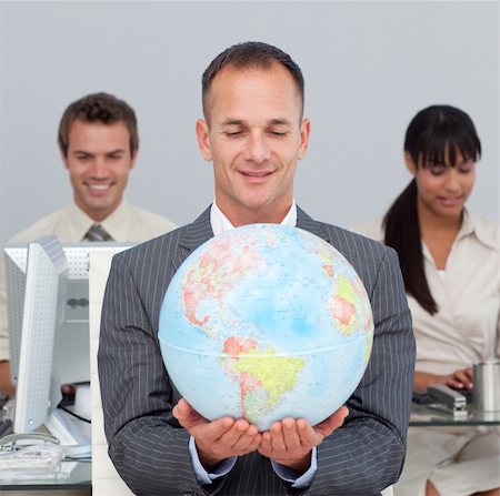 equality background hands - Assertive manager smiling at global expansion with his team in the background Stock Photo - Budget Royalty-Free & Subscription, Code: 400-04687203