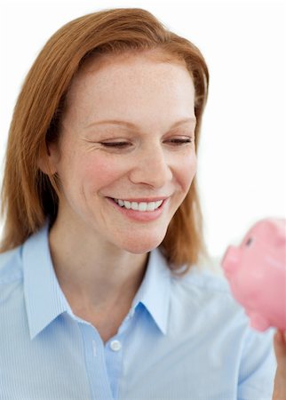 simsearch:400-05715207,k - Young businesswoman saving money in a piggybank against a white background Stock Photo - Budget Royalty-Free & Subscription, Code: 400-04687341