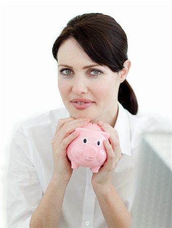 simsearch:400-05715208,k - Serious businesswoman holding a piggybank isolated on a white background Stock Photo - Budget Royalty-Free & Subscription, Code: 400-04687366