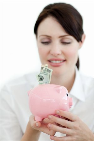 simsearch:400-05715208,k - Young businesswoman saving money in a piggybank isolated on a white background Stock Photo - Budget Royalty-Free & Subscription, Code: 400-04687368