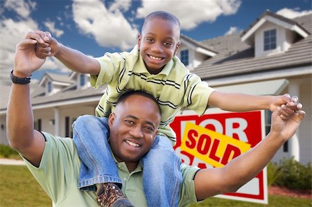 Happy African American Father and Son in Front of New Home and Sold Real Estate Sign. Foto de stock - Super Valor sin royalties y Suscripción, Código: 400-04680483