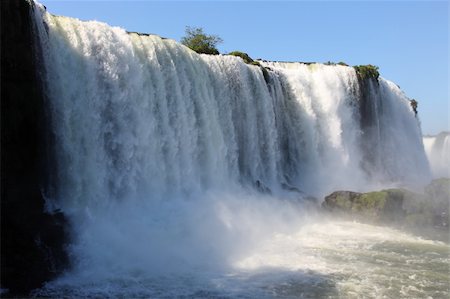 pictures of south america tropical waterfalls - Iguassu waterfalls on a sunny day early in the morning. The biggest waterfalls on earth. Stock Photo - Budget Royalty-Free & Subscription, Code: 400-04681176