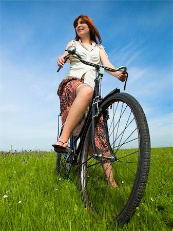 simsearch:400-03934248,k - Happy young woman on a green meadow with a vintage bicycle Stock Photo - Budget Royalty-Free & Subscription, Code: 400-04695354