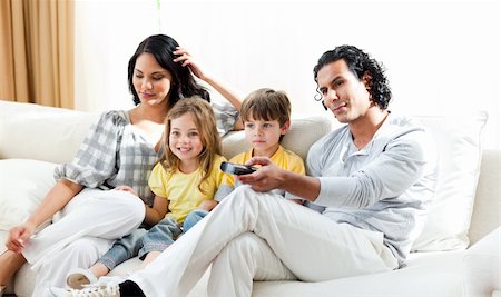 simsearch:400-04193348,k - Smiling family watching TV in the living-room Stock Photo - Budget Royalty-Free & Subscription, Code: 400-04697399