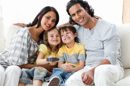 simsearch:400-04193348,k - Cheerful family watching TV  together sitting on a sofa Stock Photo - Budget Royalty-Free & Subscription, Code: 400-04697400