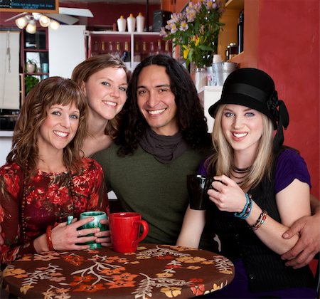 Four smiling friends enjoying coffee in a cafe Stock Photo - Budget Royalty-Free & Subscription, Code: 400-04699037