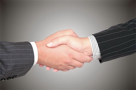 simsearch:400-04609965,k - Business handshake deal - on gray gradient background Stock Photo - Budget Royalty-Free & Subscription, Code: 400-04690498