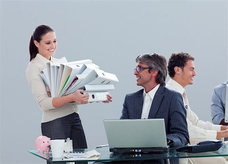 sheath - Pretty businesswoman carrying a stack of folders with her colleague in the office Stock Photo - Budget Royalty-Free & Subscription, Code: 400-04691054