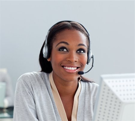simsearch:400-05287143,k - Delighted businesswoman using headset at her desk in the office Stock Photo - Budget Royalty-Free & Subscription, Code: 400-04691228
