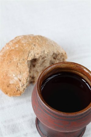 Chalice with red wine and bread in background. Shallow dof, copy space Stock Photo - Budget Royalty-Free & Subscription, Code: 400-04691560