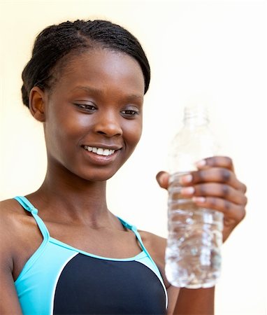 Young woman drinking water against white background Stock Photo - Budget Royalty-Free & Subscription, Code: 400-04705763