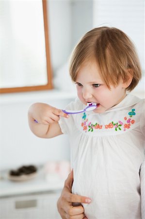 Small girl doing healthcare in bathroom Stock Photo - Budget Royalty-Free & Subscription, Code: 400-04705814